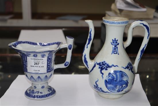 A Chinese Kangxi period blue and white wine pot and a Qianlong period helmet shaped milk jug Height of pot 16cm